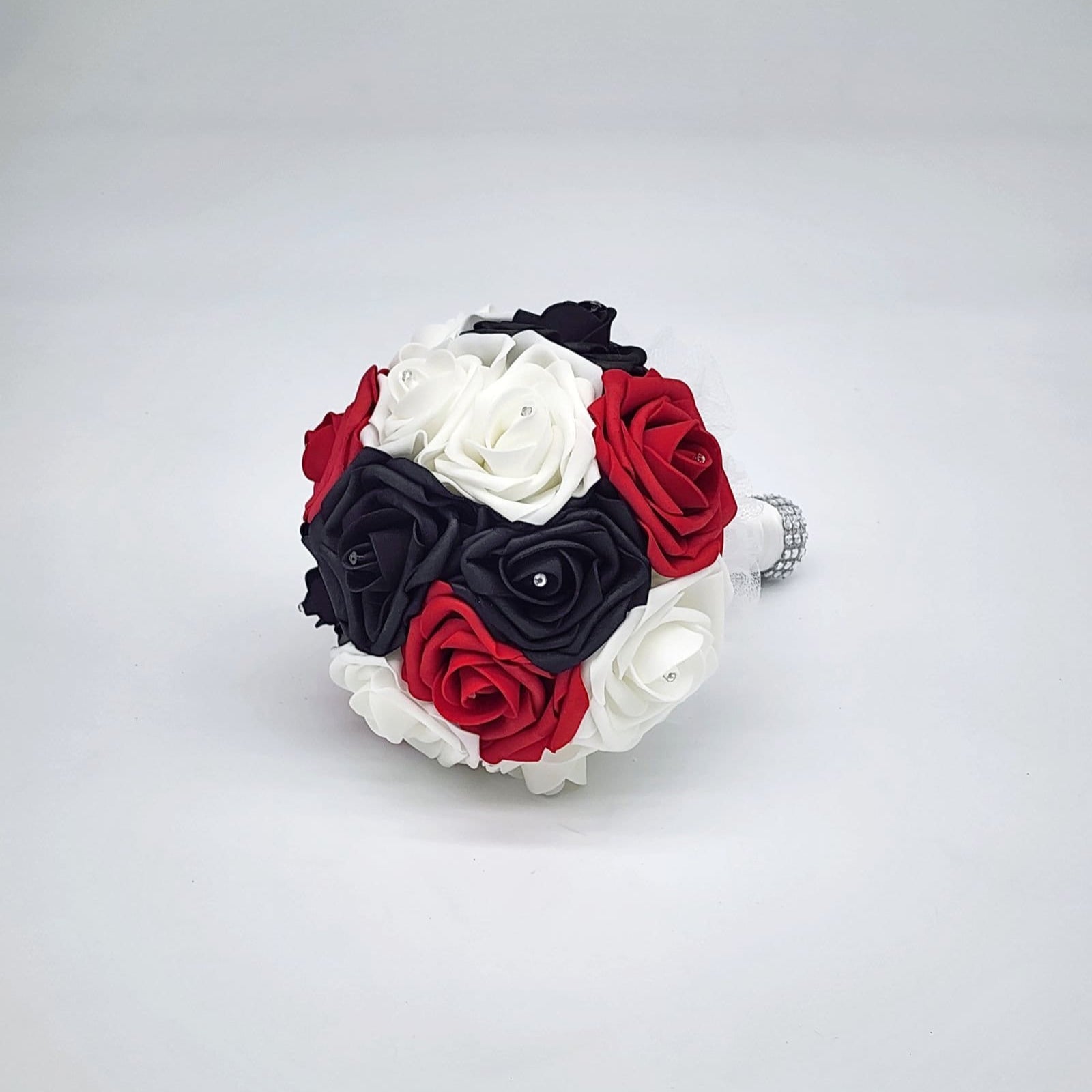 Red, black, and white wedding bouquet made with real touch roses. Bridal bouquet, bridesmaid bouquet, and matching boutonnieres and corsages