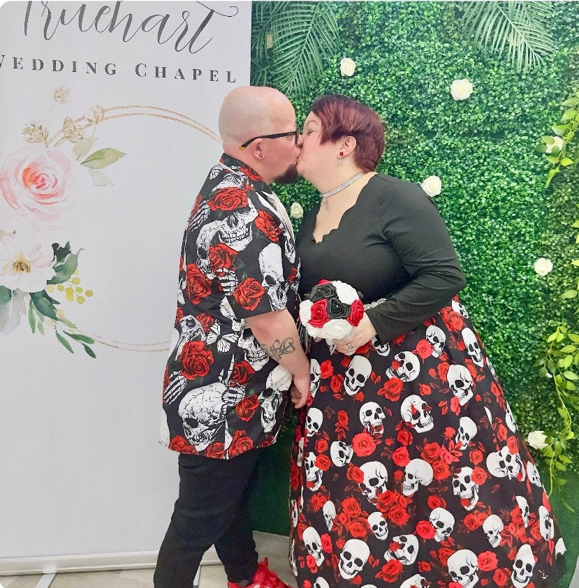 Couple holding their bouquet kissing at their wedding