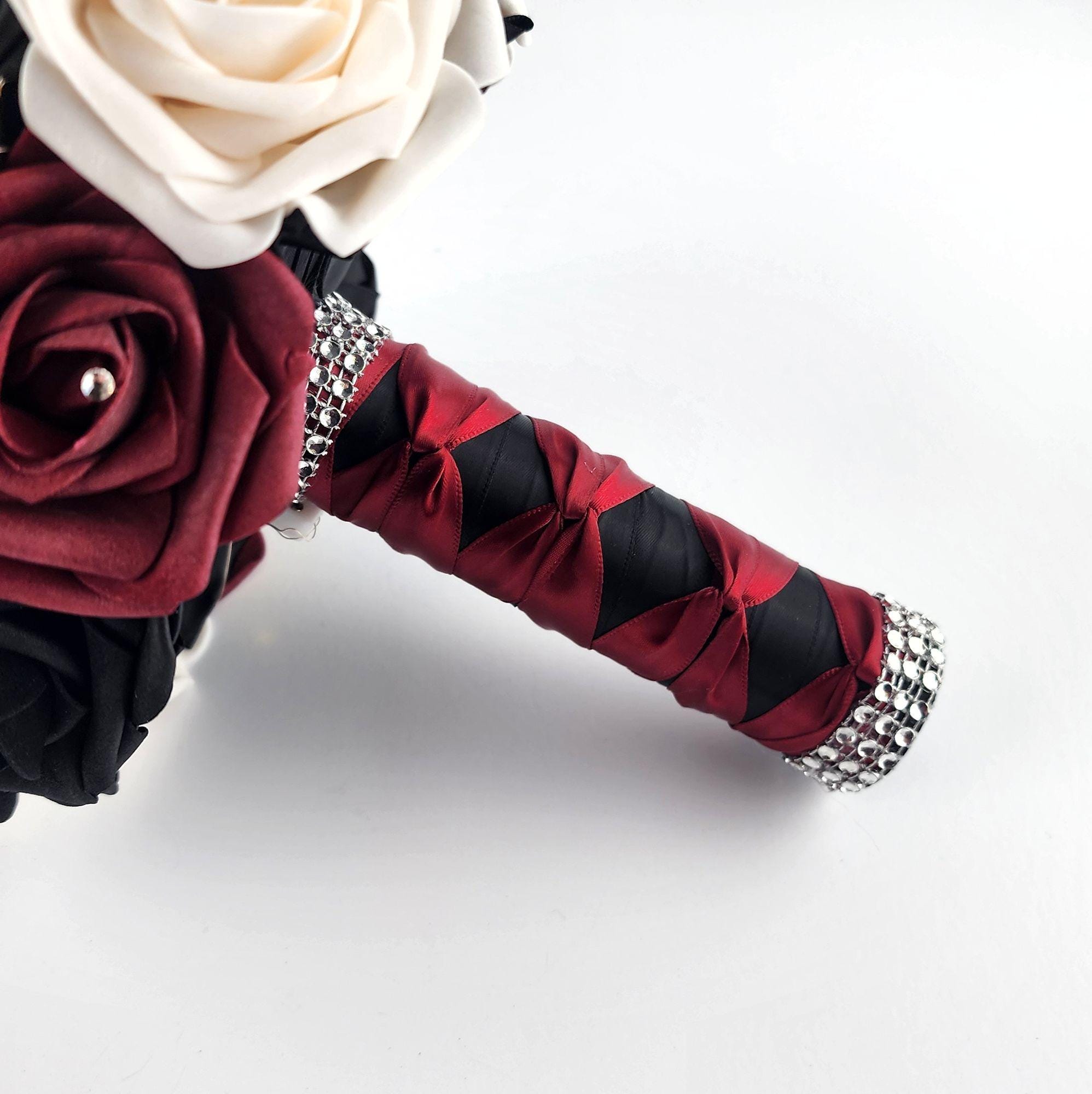 Black, Burgundy, and Cream Fairylight bouquet- Wedding bouquet-Bouquet is made using real touch roses. Handle is Blackwith a Burgundy French twist and finished with silver bling wrap. Fairy Lightsare strung through bouquet