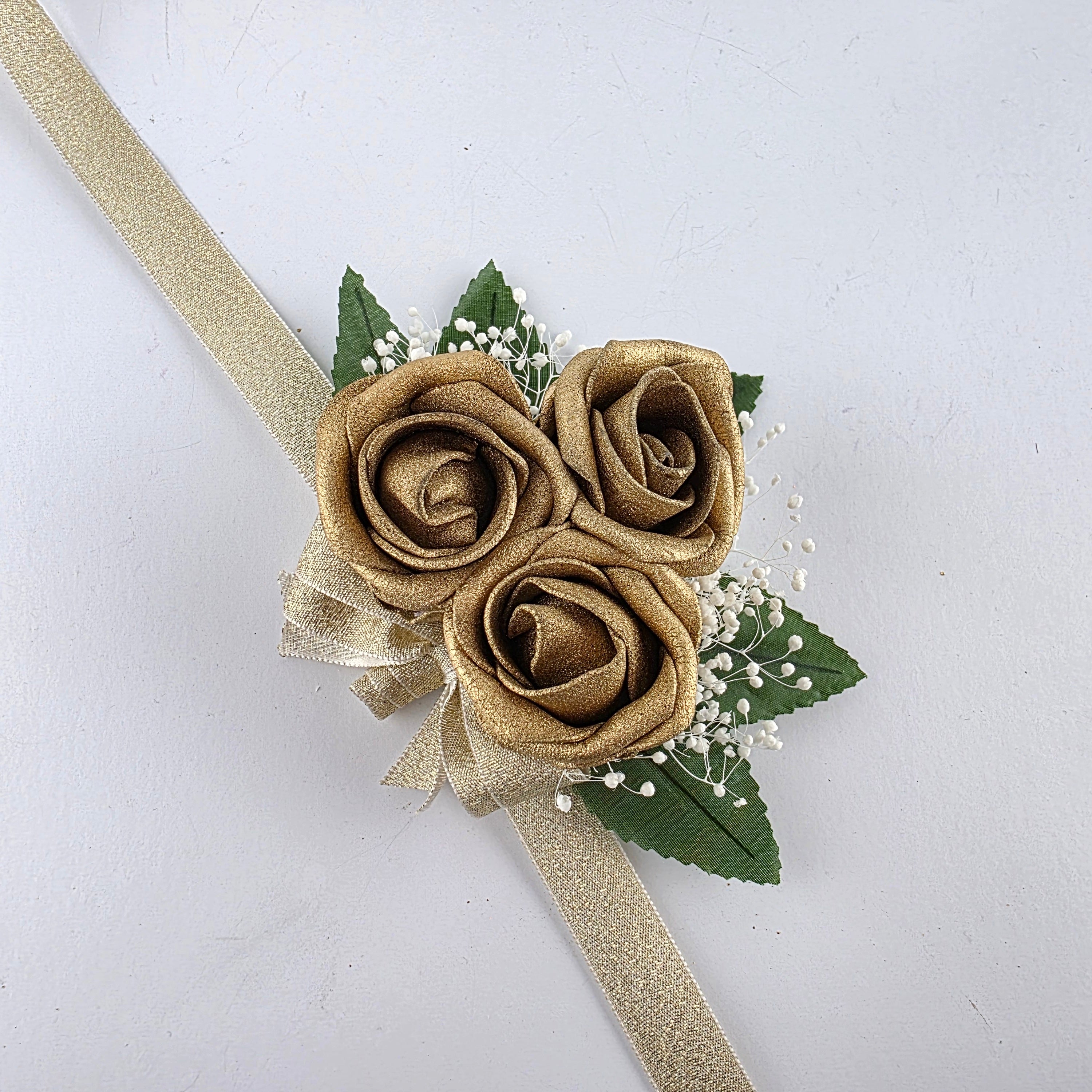 All gold wrist corsage with baby
s breath