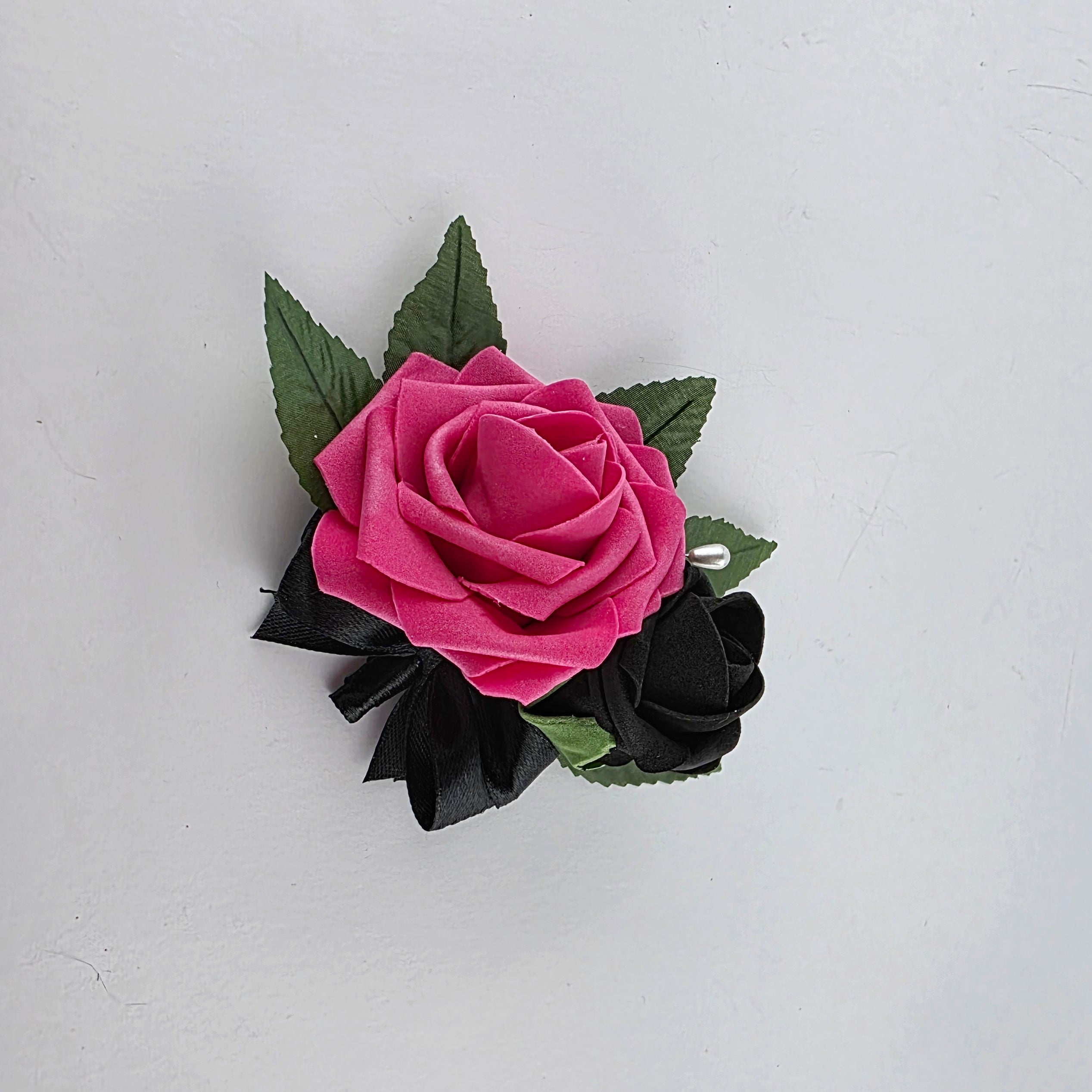 Hot pink and black pin on corsage