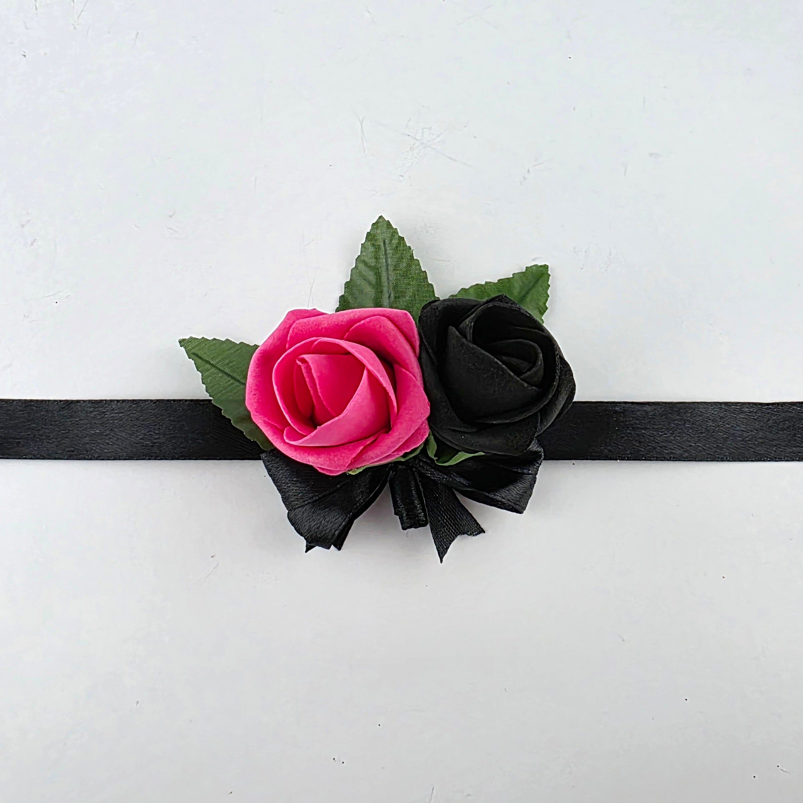 Hot pink and black wrist corsage for children
