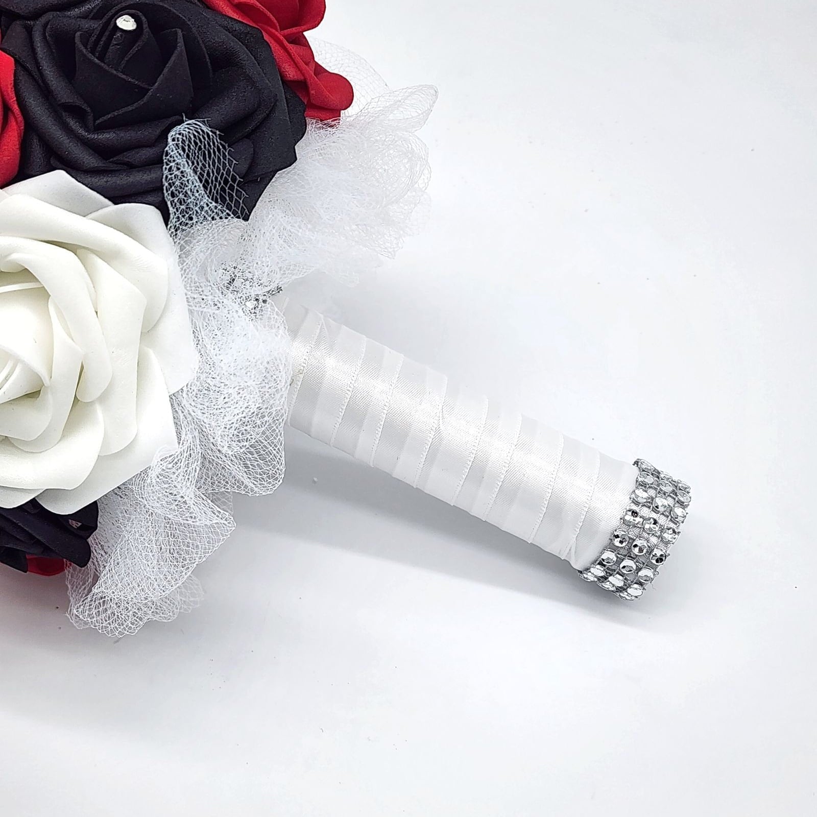 Red, black, and white wedding bouquet made with real touch roses. Bridal bouquet, bridesmaid bouquet, and matching boutonnieres and corsages