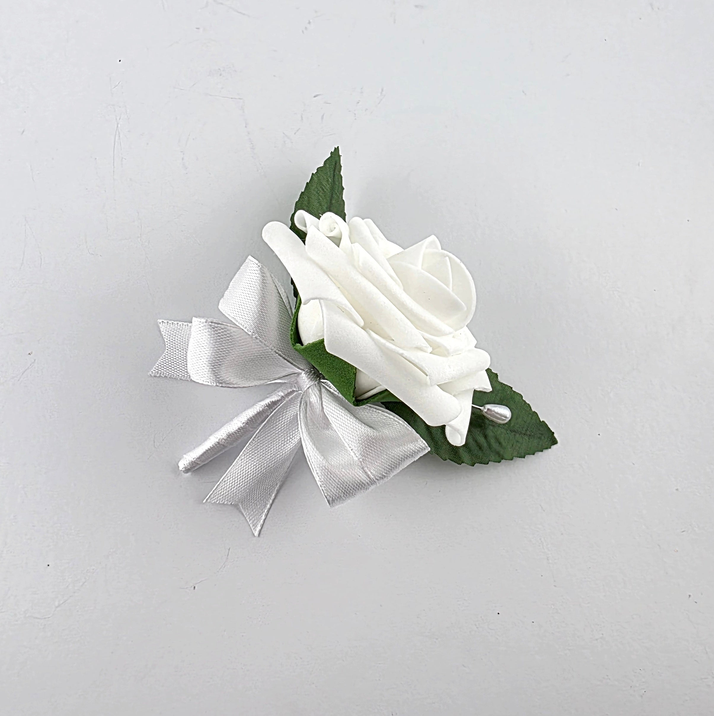 white pin on boutonniere