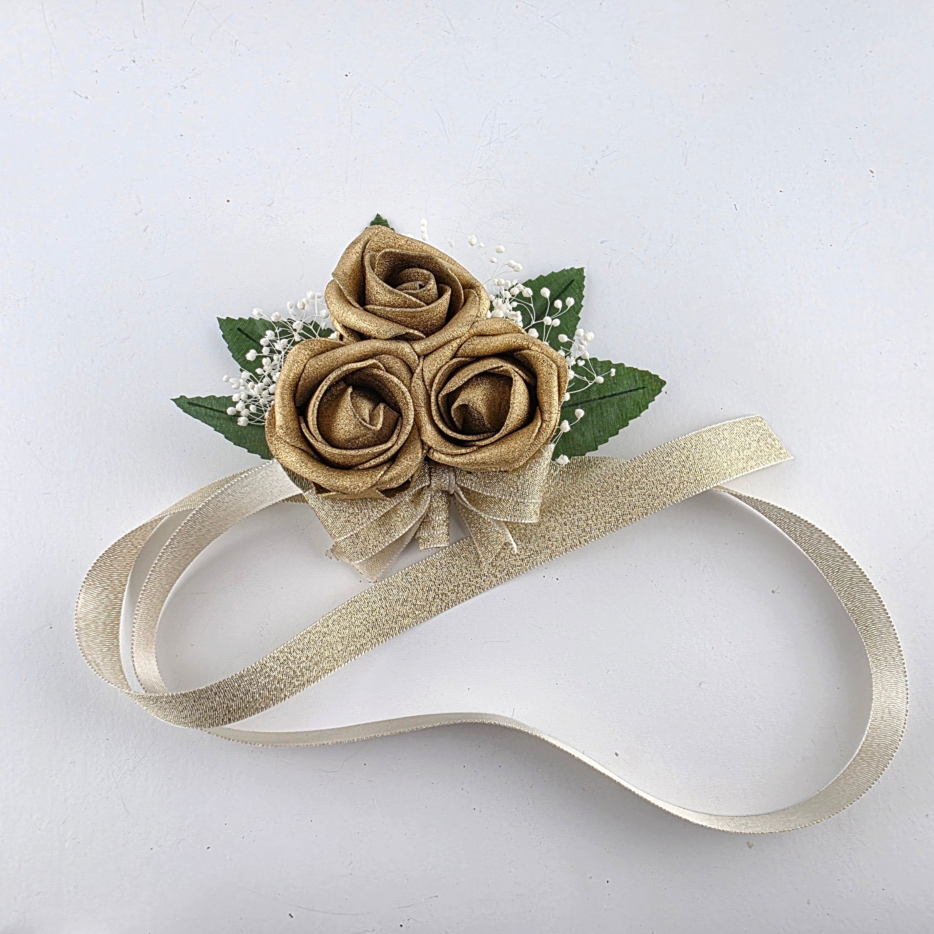 gold corsage with gold ribbon
