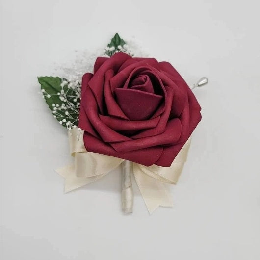 Burgundy and ivory boutonniere with baby's breath