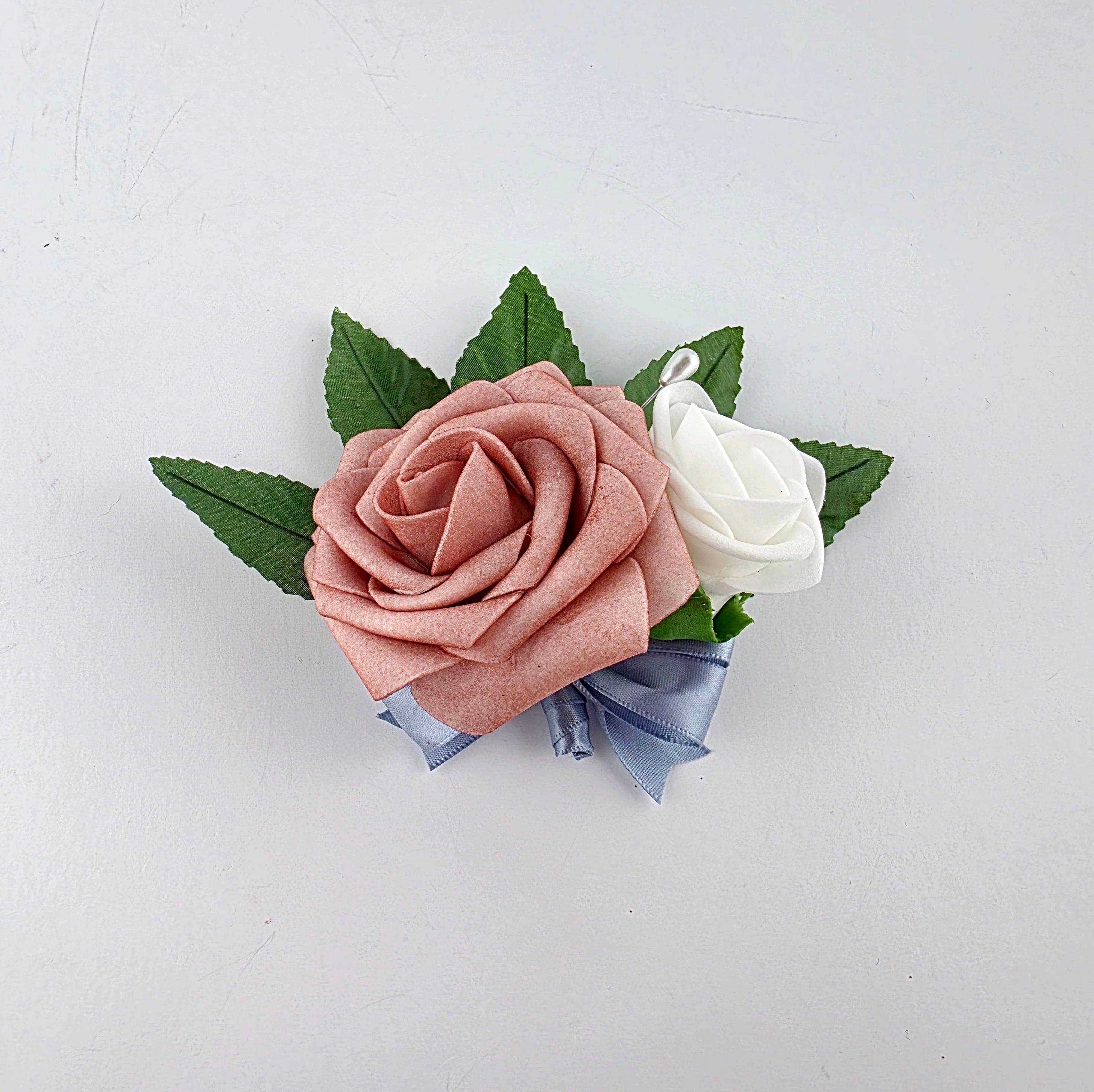 dusty rose and white pin on corsage